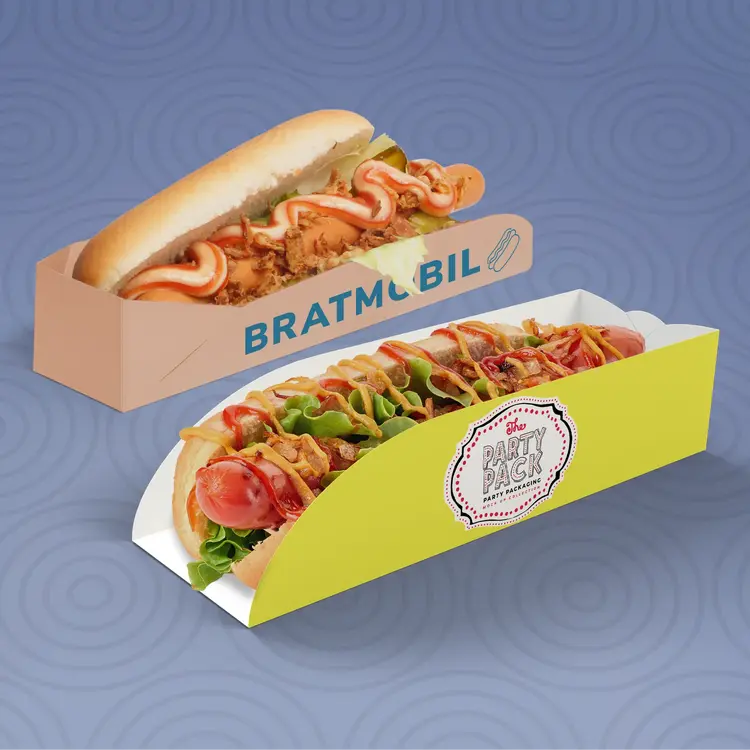 Deux hot-dogs dans un emballage : l'un étiqueté "BRATMOBIL" à gauche et l'autre en jaune étiqueté "Party Pack" à droite.
